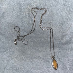 Coca leaf charm with chain.